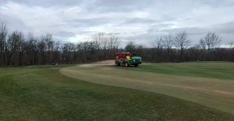 All Greens Tined, Fertilised & Topdressed